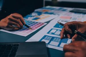The designer team is designing the uxui system to make the uxui system work well on new phones and support system updates. Website development concept UI UX front end designer photo