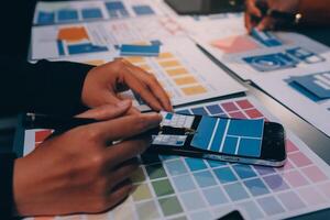 The designer team is designing the uxui system to make the uxui system work well on new phones and support system updates. Website development concept UI UX front end designer photo
