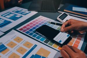 The designer team is designing the uxui system to make the uxui system work well on new phones and support system updates. Website development concept UI UX front end designer photo