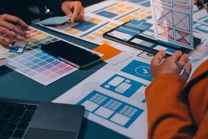 The designer team is designing the uxui system to make the uxui system work well on new phones and support system updates. Website development concept UI UX front end designer photo