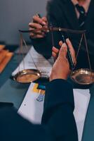 Judge gavel with Justice lawyers having team meeting at law firm background. Concepts of Law and Legal services. photo