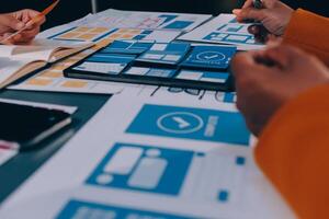 The designer team is designing the uxui system to make the uxui system work well on new phones and support system updates. Website development concept UI UX front end designer photo