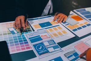 The designer team is designing the uxui system to make the uxui system work well on new phones and support system updates. Website development concept UI UX front end designer photo
