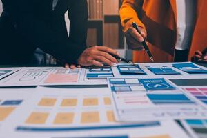The designer team is designing the uxui system to make the uxui system work well on new phones and support system updates. Website development concept UI UX front end designer photo