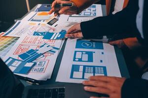 The designer team is designing the uxui system to make the uxui system work well on new phones and support system updates. Website development concept UI UX front end designer photo
