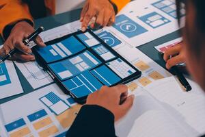 The designer team is designing the uxui system to make the uxui system work well on new phones and support system updates. Website development concept UI UX front end designer photo