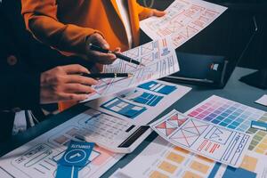 The designer team is designing the uxui system to make the uxui system work well on new phones and support system updates. Website development concept UI UX front end designer photo