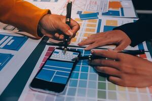 The designer team is designing the uxui system to make the uxui system work well on new phones and support system updates. Website development concept UI UX front end designer photo