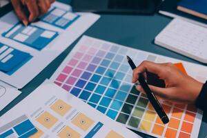 The designer team is designing the uxui system to make the uxui system work well on new phones and support system updates. Website development concept UI UX front end designer photo