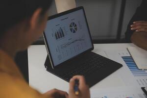 Close up of Business team analyzing income charts and graphs with modern laptop computer. Business analysis and strategy concept. photo