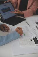 Close up of Business team analyzing income charts and graphs with modern laptop computer. Business analysis and strategy concept. photo