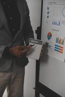 Close up of Business team analyzing income charts and graphs with modern laptop computer. Business analysis and strategy concept. photo
