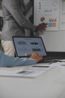 Close up of Business team analyzing income charts and graphs with modern laptop computer. Business analysis and strategy concept. photo