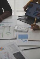 Close up of Business team analyzing income charts and graphs with modern laptop computer. Business analysis and strategy concept. photo