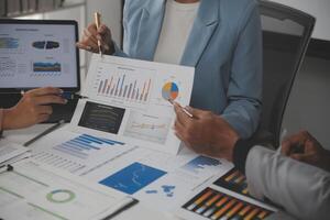 Close up of Business team analyzing income charts and graphs with modern laptop computer. Business analysis and strategy concept. photo