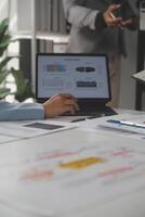 Close up of Business team analyzing income charts and graphs with modern laptop computer. Business analysis and strategy concept. photo