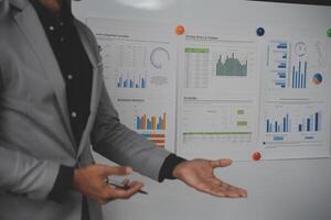 Close up of Business team analyzing income charts and graphs with modern laptop computer. Business analysis and strategy concept. photo