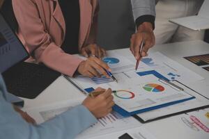 Close up of Business team analyzing income charts and graphs with modern laptop computer. Business analysis and strategy concept. photo