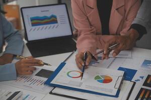 Close up of Business team analyzing income charts and graphs with modern laptop computer. Business analysis and strategy concept. photo