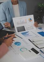 Close up of Business team analyzing income charts and graphs with modern laptop computer. Business analysis and strategy concept. photo