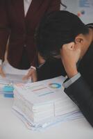Audit concept,Administrator business man financial inspector and secretary making report calculating balance. Internal Revenue Service checking document. photo