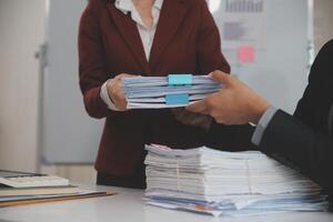Audit concept,Administrator business man financial inspector and secretary making report calculating balance. Internal Revenue Service checking document. photo