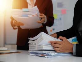 Audit concept,Administrator business man financial inspector and secretary making report calculating balance. Internal Revenue Service checking document. photo