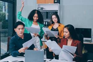 Stress, business people and employee frustrated with multitasking, pressure or overworked by team in chaos with paperwork. Anxiety, headache and worker overwhelmed by group and burnout in crisis photo