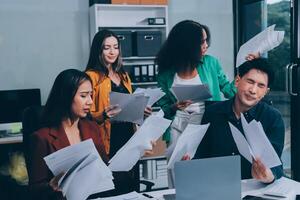 Stress, business people and employee frustrated with multitasking, pressure or overworked by team in chaos with paperwork. Anxiety, headache and worker overwhelmed by group and burnout in crisis photo