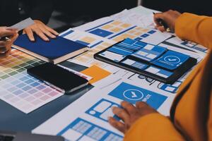The designer team is designing the uxui system to make the uxui system work well on new phones and support system updates. Website development concept UI UX front end designer photo