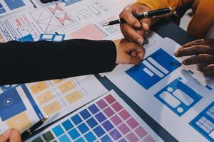 The designer team is designing the uxui system to make the uxui system work well on new phones and support system updates. Website development concept UI UX front end designer photo