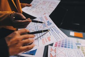 The designer team is designing the uxui system to make the uxui system work well on new phones and support system updates. Website development concept UI UX front end designer photo