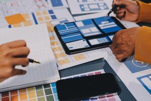 The designer team is designing the uxui system to make the uxui system work well on new phones and support system updates. Website development concept UI UX front end designer photo