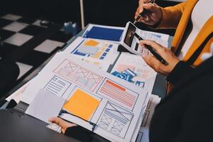 The designer team is designing the uxui system to make the uxui system work well on new phones and support system updates. Website development concept UI UX front end designer photo