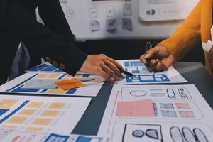 The designer team is designing the uxui system to make the uxui system work well on new phones and support system updates. Website development concept UI UX front end designer photo