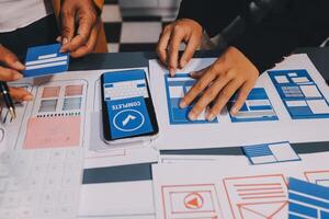 The designer team is designing the uxui system to make the uxui system work well on new phones and support system updates. Website development concept UI UX front end designer photo