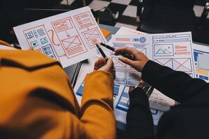 The designer team is designing the uxui system to make the uxui system work well on new phones and support system updates. Website development concept UI UX front end designer photo