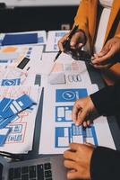 The designer team is designing the uxui system to make the uxui system work well on new phones and support system updates. Website development concept UI UX front end designer photo