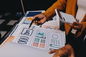 The designer team is designing the uxui system to make the uxui system work well on new phones and support system updates. Website development concept UI UX front end designer photo