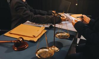 Judge gavel with Justice lawyers having team meeting at law firm background. Concepts of Law and Legal services. photo