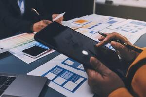 The designer team is designing the uxui system to make the uxui system work well on new phones and support system updates. Website development concept UI UX front end designer photo