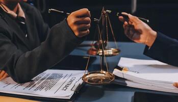 Judge gavel with Justice lawyers having team meeting at law firm background. Concepts of Law and Legal services. photo