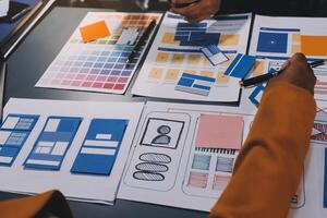 The designer team is designing the uxui system to make the uxui system work well on new phones and support system updates. Website development concept UI UX front end designer photo