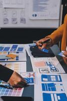The designer team is designing the uxui system to make the uxui system work well on new phones and support system updates. Website development concept UI UX front end designer photo