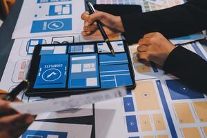 The designer team is designing the uxui system to make the uxui system work well on new phones and support system updates. Website development concept UI UX front end designer photo