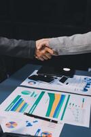 Handshake as successful negotiation ending, close-up. Unknown business people shaking hands after contract signing in modern office photo