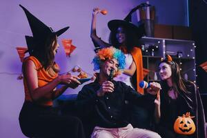Joyful office Halloween party with coworkers in costumes, celebrating with drinks and laughter, fostering teamwork and festive spirit photo