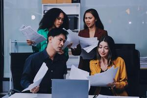 Stress, business people and employee frustrated with multitasking, pressure or overworked by team in chaos with paperwork. Anxiety, headache and worker overwhelmed by group and burnout in crisis photo
