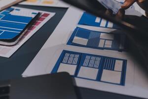 The designer team is designing the uxui system to make the uxui system work well on new phones and support system updates. Website development concept UI UX front end designer photo