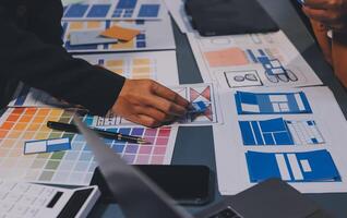 The designer team is designing the uxui system to make the uxui system work well on new phones and support system updates. Website development concept UI UX front end designer photo